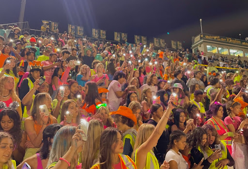 Student section swayed their flashlights to the song, Flashing Lights, by Kayne West.