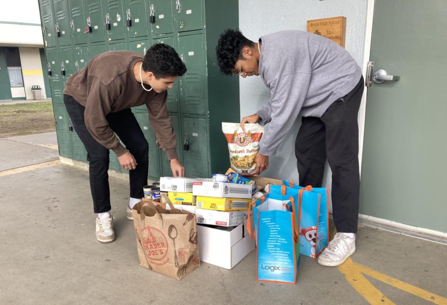 Seniors Kevin Bautista and Meelad Zarrabi collecting cans from classes during 3rd period.