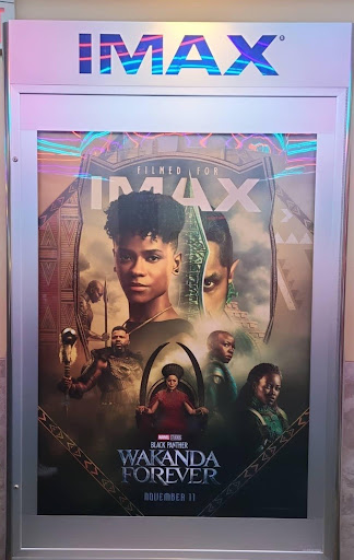 Black Panther: Wakanda Forever poster in the front of Regal Theater in Simi Valley with an IMAX frame. The poster contains Okoye and one other person apart from the Dora Milaje as well as M’Baku, Nakia, Romanda, the protagonist of the movie, and Shuri, who seems to be the protagonist of this movie.