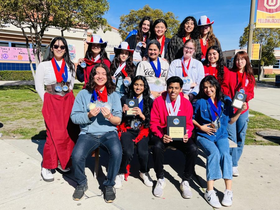 Members of the Academic Decathlon showing off their trophies and individual medals.