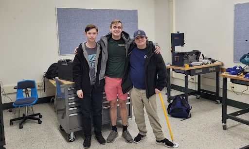 Seniors Eric Smith, Kevin Kopcinski, and junior Jack VanKannel in the Robotics Club room.