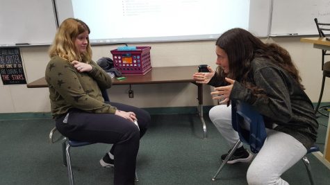 Sophsmores Krystal Waters and Victoria Kahoe acting out an interrogation scene.