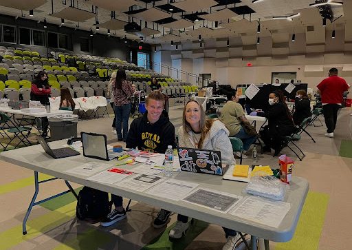 Senior Evan Nagy and Mrs. Lev signing students in for donating their blood.