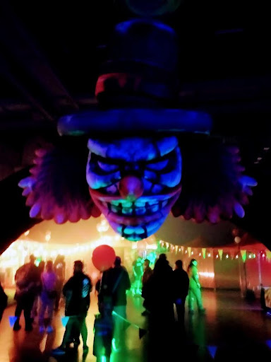Giant Clown Head Looming Over Crowd