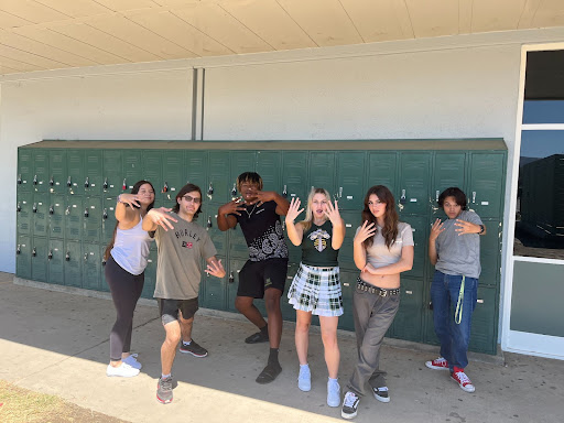 Our broadcasting crew standing outside the studio throwing up them fours.