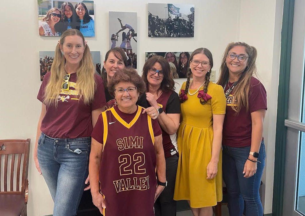 Some+of+our+friendly+office+staff+and+administrators+wearing+their+rivalry+gear.