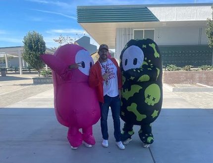 Two students with one of our many beloved campus supervisors on Halloween.