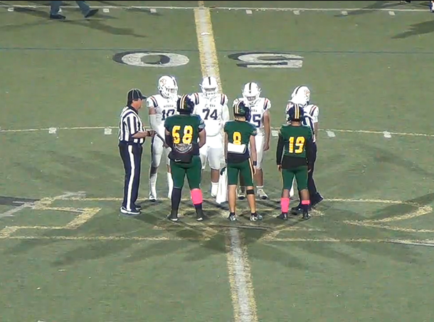 The Highlanders captions and the Charger’s captions face off at mid-field for the coin toss.