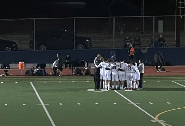 Highlanders huddling together in the field during halftime. They utimately won the game against Burbank High School.
