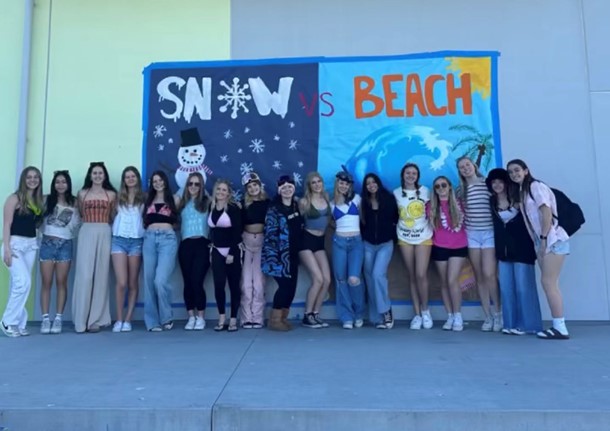 A group of students showing off their snow versus beach outfits on Tuesday, January 30.
