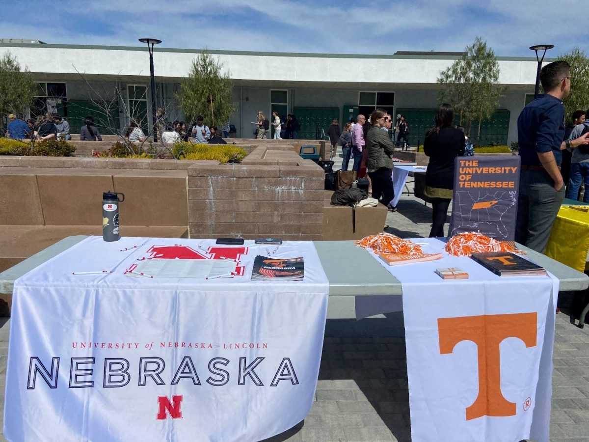 University of Nebraska-Lincoln and University of Tennessee setting up tables before the start of the mini college fair. 