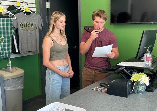 Junior Luke Lacy reading off the morning announcements alongside senior Zoe Misiowiec