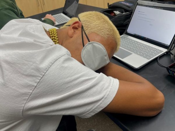 A student asleep before class starts.