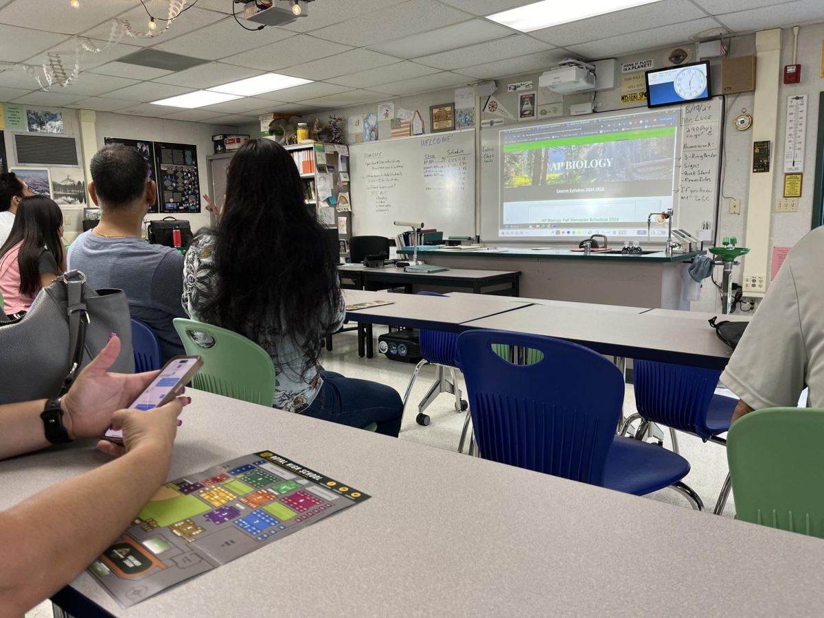 Students and parents sitting in class to learn more about the upcoming year in AP Biology.