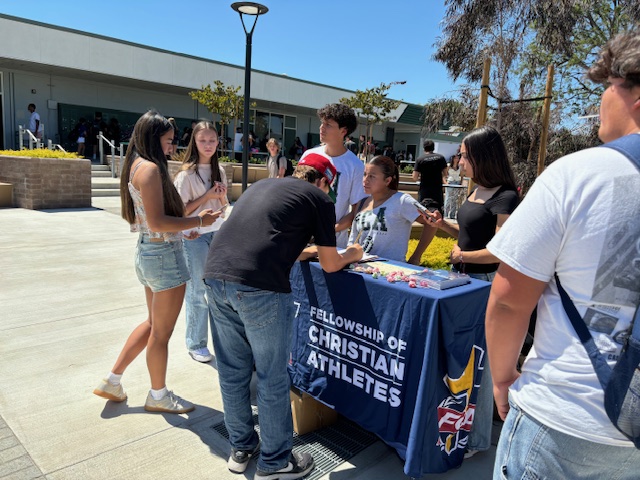 Students selecting to join the Fellowship of Christian Athletes club.