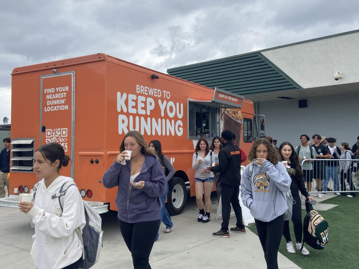 Students trying the new Kiwi Watermelon Lemonade Refresher from the Dunkin Donuts truck.