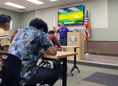 Mike James presenting his views for the school board to students. 