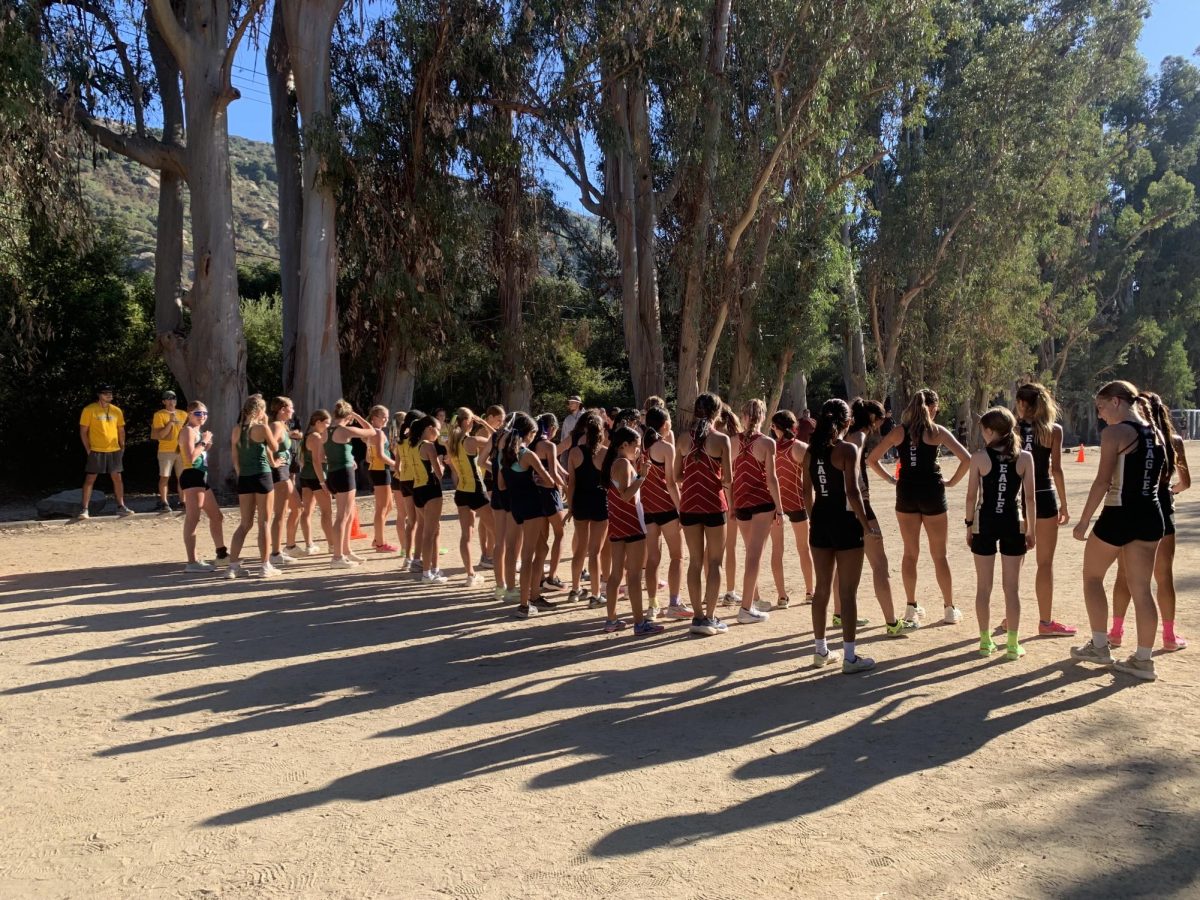 Varsity girls on the starting line about to start their race.