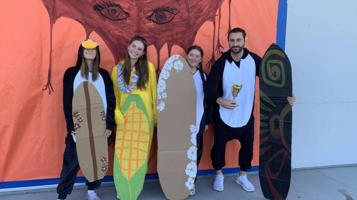 Mr. Habroun and some of his students dressed as penguin characters from the movie "Surfs Up" on Halloween.