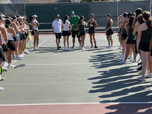 The two varsity tennis teams before the match, meeting the competition through sportsmanship.