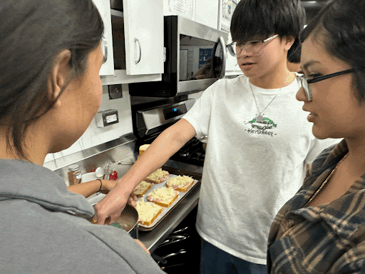 Students teaming up to make the French dish.