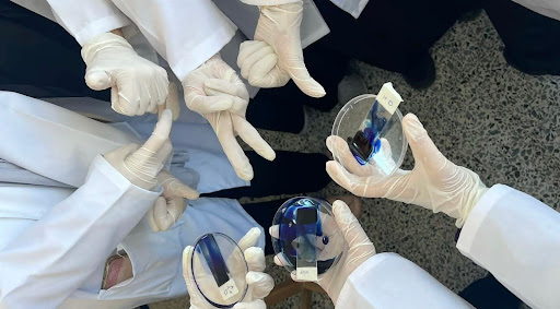 UC Berkeley medical students gathered together, all putting their hands in the center in solidarity, taken by Sabina Taha, a senior medical student at UC Berkeley.