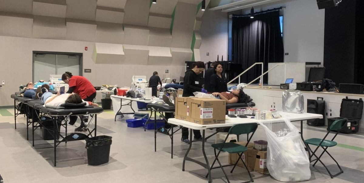 Students and teachers getting one pint of blood drawn at the blood drive station.
