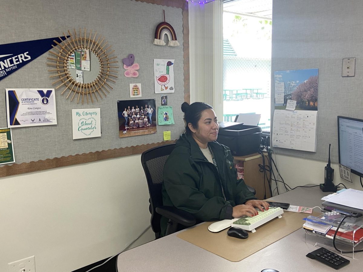 Ms Campos working on her new desk in her brand new College and Career classroom in room (6-9).