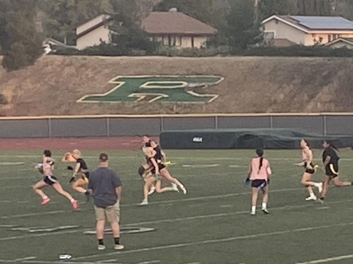 Juniors vs Seniors playing flag football for the Empowerpuff game held at the Highlander Stadium.