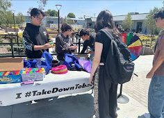 David Chen and Evie Azizpour give out prizes at their booth during lunch.